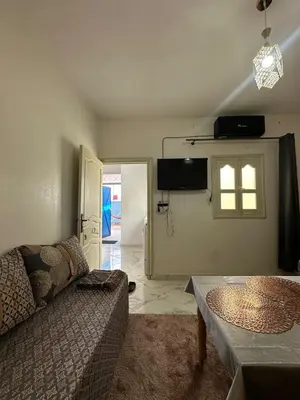 a living room with a couch and a window at A unique and cute apartment in a prime location in Er Rachidia