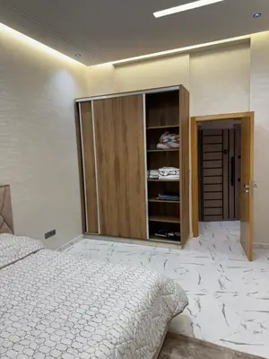 a bedroom with a bed and a cupboard at Calm Elegant Apartment City Center with Garage in Fès