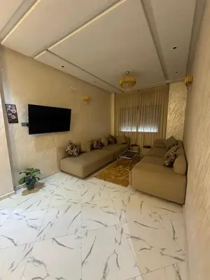 a living room with couches and a flat screen tv at Calm Elegant Apartment City Center with Garage in Fès
