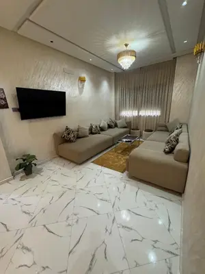 a living room with two couches and a flat screen tv at Calm Elegant Apartment City Center with Garage in Fès