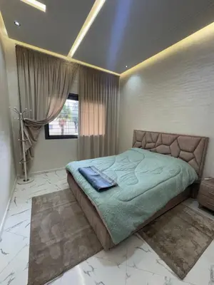 a bedroom with a large bed in a room at Calm Elegant Apartment City Center with Garage in Fès