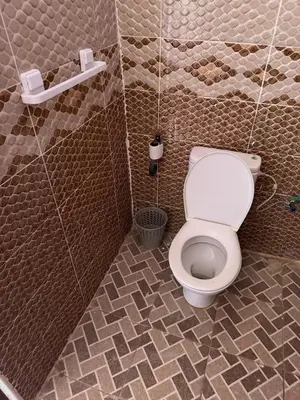 a bathroom with a toilet in a stall at Maison La Baraka Merzouga in Merzouga