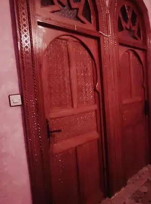 a wooden door in a room with at Kasabah Senhaji in Moulay Idriss Zerhoun