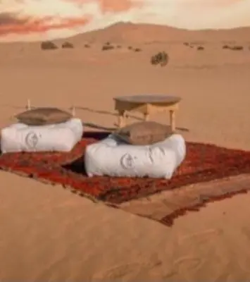 a painting of three objects in the desert at Merzouga Camping Sahara in Hassilabied