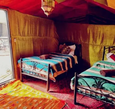 a bedroom with two beds in a room at Merzouga Camping Sahara in Hassilabied