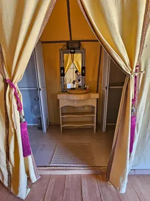 a room with a dressing table and a mirror at Merzouga Hero luxury Glamping in Merzouga