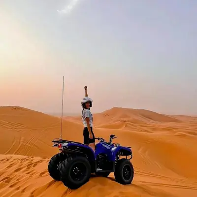 a person on a quad bike in the desert at Merzouga Hero luxury Glamping in Merzouga