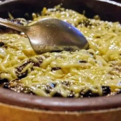 a spoon in a bowl of food with pasta at Merzouga Hero luxury Glamping in Merzouga