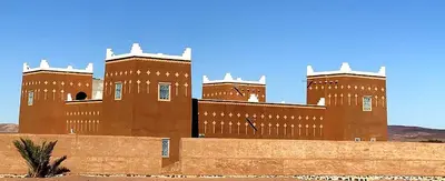 a large brown building with two towers on top at Guest house Kasbah Foum Tizza in Boikhlal