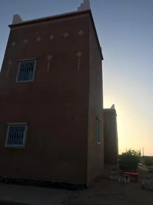 a building with stars on the side of it at Guest house Kasbah Foum Tizza in Boikhlal
