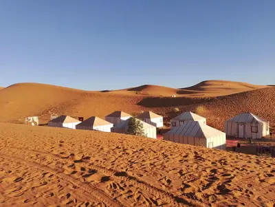 a village in the middle of a desert at Afraklie Camp in Merzouga