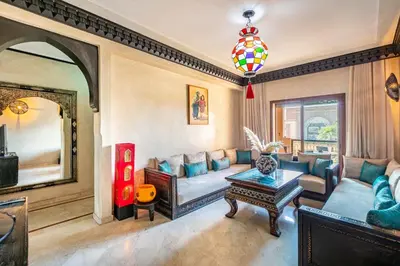 a living room with a couch and a table at Luxury Suite charming and comfortable in Oulad Akkou