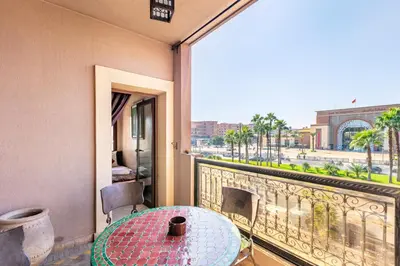 a balcony with a table and a view of the city at Luxury Suite charming and comfortable in Oulad Akkou