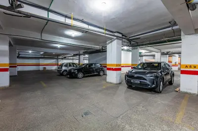 a parking garage with three cars parked in it at Luxury Suite charming and comfortable in Oulad Akkou