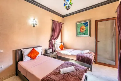 a hotel room with two beds and a window at Luxury Suite charming and comfortable in Oulad Akkou