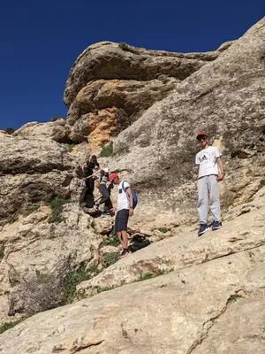 a group of people standing on some rocks at Chez Noureddine L 'GARAH in Kermets
