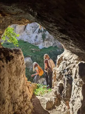 a group of people walking through a cave at Chez Noureddine L 'GARAH in Kermets