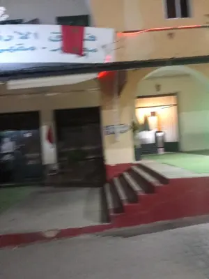 a blurry picture of a train station with a bench at Hôtel monument historique situé au centre de la ville in Azrou