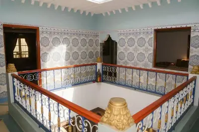 a room with a balcony with a vase on the floor at Dar Atlas, Piscine & Jacuzzi Sans Vis-à-Vis in Sbiti