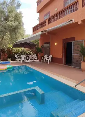 a swimming pool in front of a building at Dar Atlas, Piscine & Jacuzzi Sans Vis-à-Vis in Sbiti
