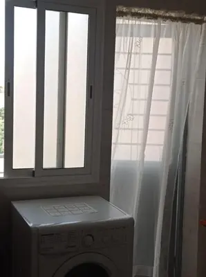 a washing machine in a room with a window at appartement neuf au premier etage in Fès