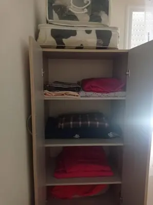 a shelf in a closet filled with towels and bowls at appartement neuf au premier etage in Fès