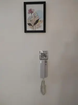 a phone hanging on a wall with a picture at rdc surélevé neuf a 10 min du centre ville in Fès
