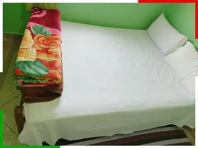 a white bed with a pillow on top of it at Spacious apartment for families near Ouzoud Falls in Azilal
