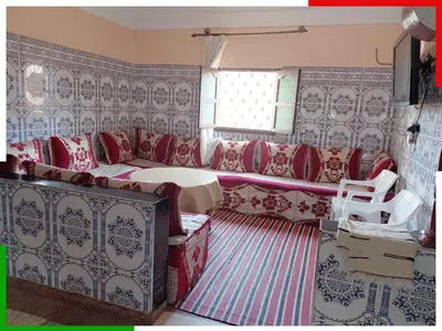 a living room with a couch and a table at Spacious apartment for families near Ouzoud Falls in Azilal