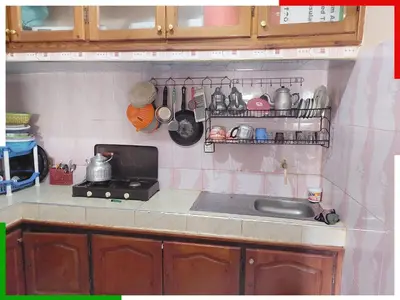 a kitchen counter with a sink and utensils at Spacious apartment for families near Ouzoud Falls in Azilal