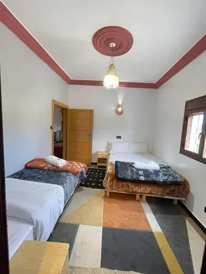 a bedroom with two beds and a ceiling at Auberge Restaurant Camping Taghzout in Agoudal