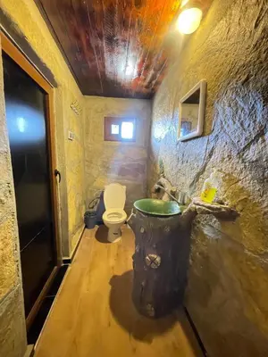 a bathroom with a toilet and a sink at Auberge Restaurant Camping Taghzout in Agoudal