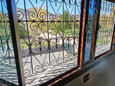 a glass window with a view of a street at Auberge Restaurant Camping Taghzout in Agoudal