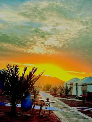 a painting of a sunset in the desert at Tigmi Desert Camp in Merzouga