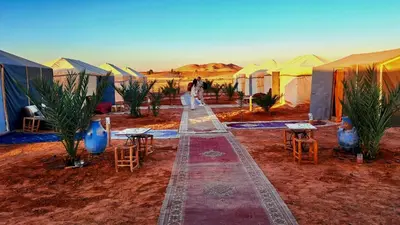 a group of tents in the middle of the desert at Tigmi Desert Camp in Merzouga