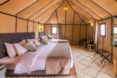 a bedroom with a large bed in a tent at Avatar Luxe Camp in Merzouga