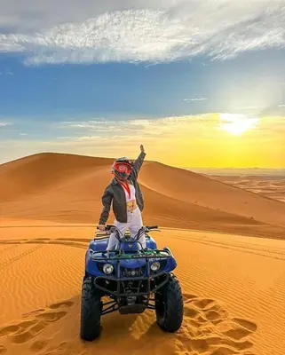 a person on a four wheeler in the desert at Avatar Luxe Camp in Merzouga