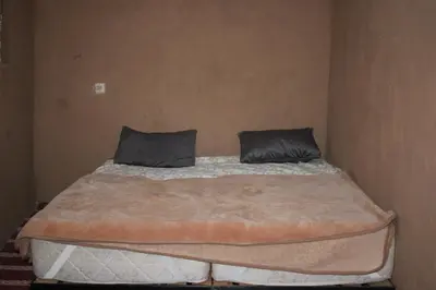 a bed in a room with two pillows on it at Dar salam in Mhamid