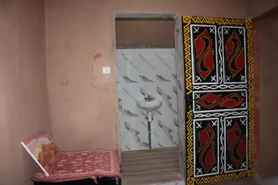 a bathroom with a sink and a mirror and a chair at Dar salam in Mhamid