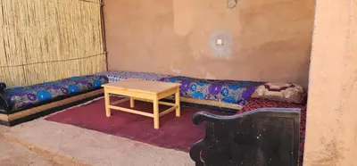 a room with a couch and a table in it at Dar salam in Mhamid