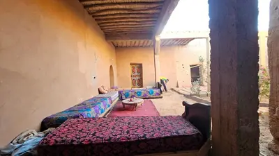 a living room with two couches and a table at Dar salam in Mhamid