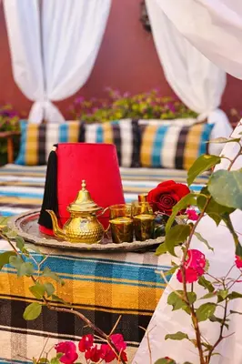 a table with a tea pot and candles on it at dar d'art Marrakech in Sraïri