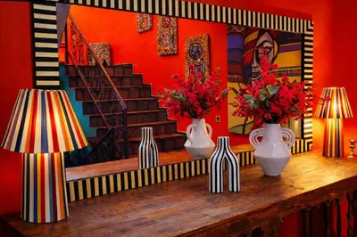 a room with vases and flowers on a wooden table at dar d'art Marrakech in Sraïri
