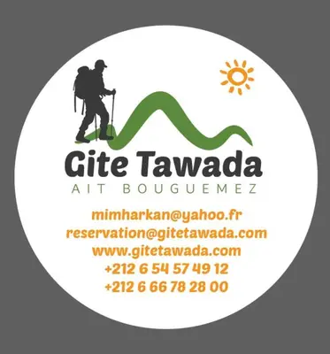 a man on a mountain with a trekking pole and a green ribbon at Hôtel Tawada in Azilal