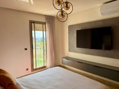 a bedroom with a bed with a tv and a window at The Hermes pearl in Fès