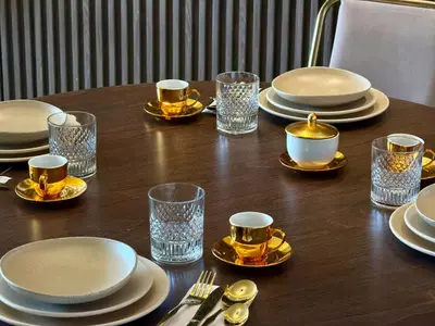 a wooden table with plates and glasses on it at The Hermes pearl in Fès