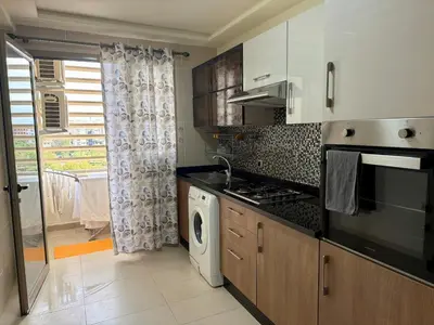 a kitchen with a stove top oven next to a window at The Hermes pearl in Fès