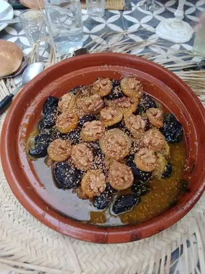 a bowl of food with shrimp and blueberries on a table at Villa privative el marjaa in Ouled el guerne