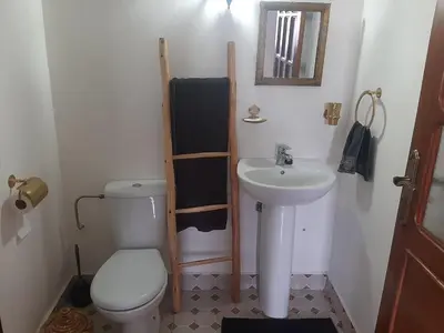 a small bathroom with a toilet and a sink at Villa privative el marjaa in Ouled el guerne