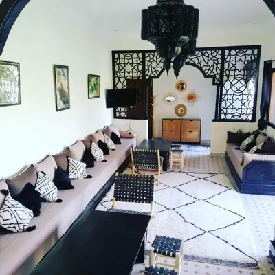 a living room with couches and a table at Villa privative el marjaa in Ouled el guerne